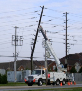 Lines crew working on a damaged pole